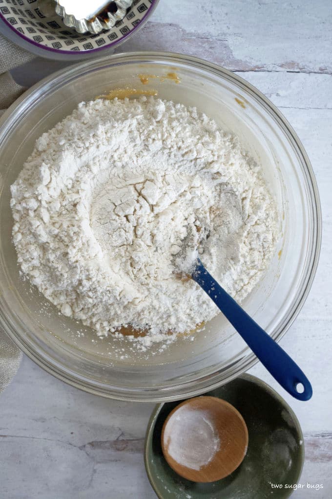 flour, baking powder and salt on top of wet ingredients in a bowl