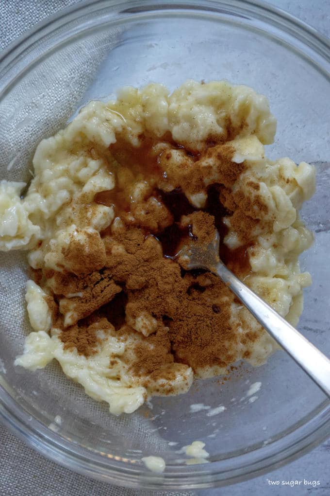 mashed bananas with cinnamon, rum and banana liquor in a mixing bowl