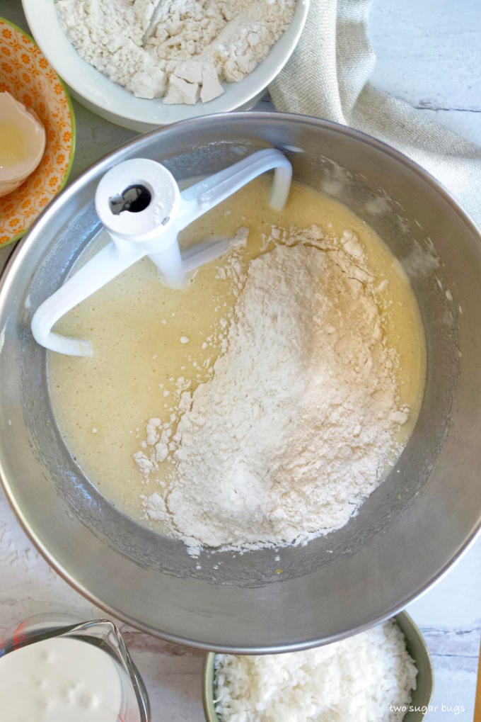 batter with half the flour added in a mixing bowl