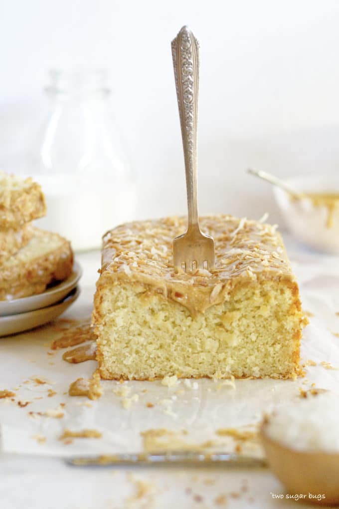 kona coconut loaf cake with a fork stuck in the top of it