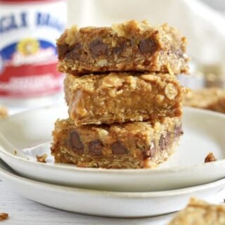 Stack of three pumpkin caramel spice bars on a plate.