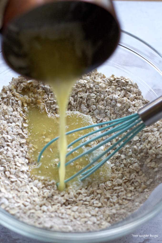 butter being poured into oat mixture