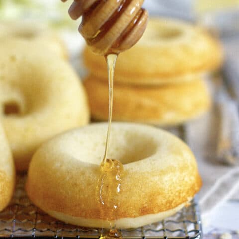 cornbread donut being drizzled with honey