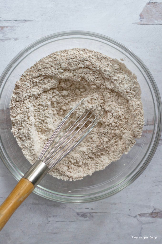 dry muffin ingredients in a bowl with a whisk