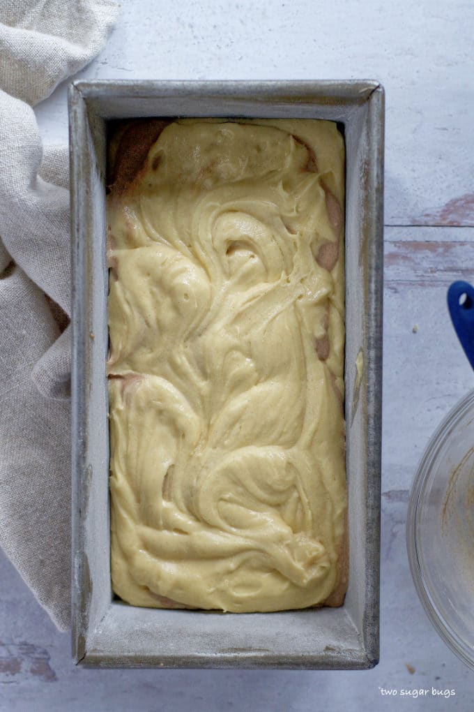 pound cake batter swirled together in a loaf pan
