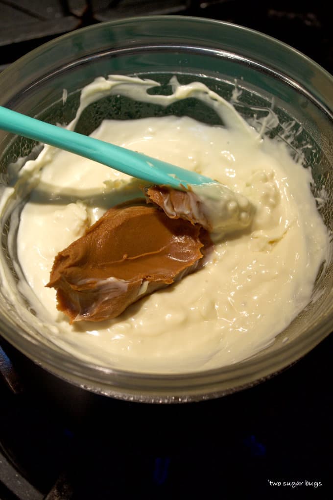 white chocolate and cookie butter in a double boiler on the stove