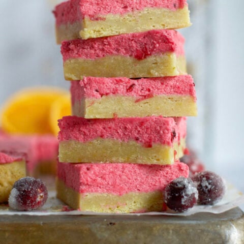 stack of five orange cranberry sugar cookies bars on a baking sheet
