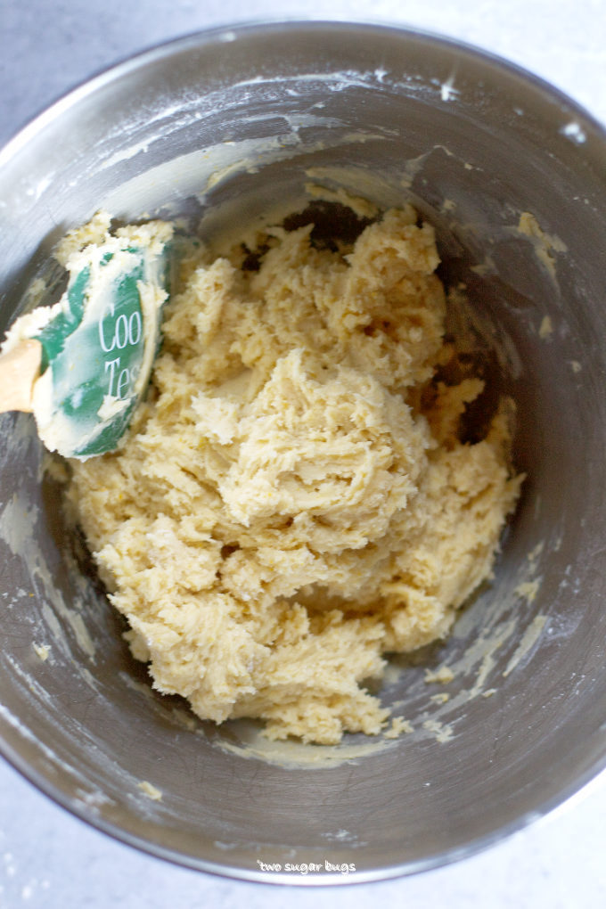 orange sugar cookie dough in a mixing bowl