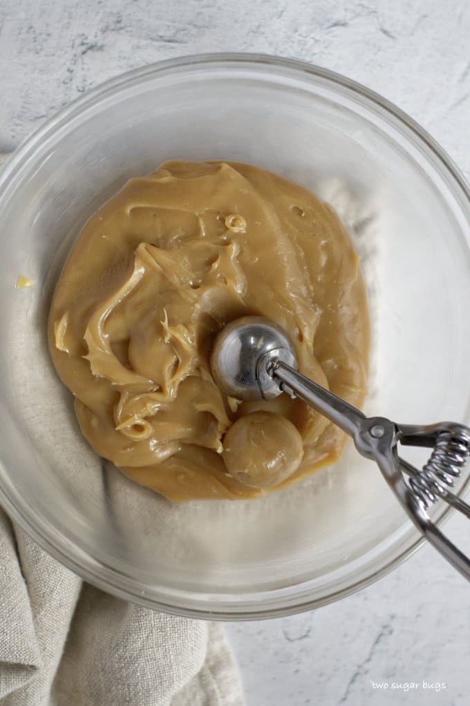 chilled cookie butter brigaderio in a bowl with a measuring scoop