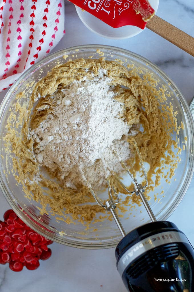 flour on top of creamed butter, sugars, eggs and vanilla in a mixing bowl