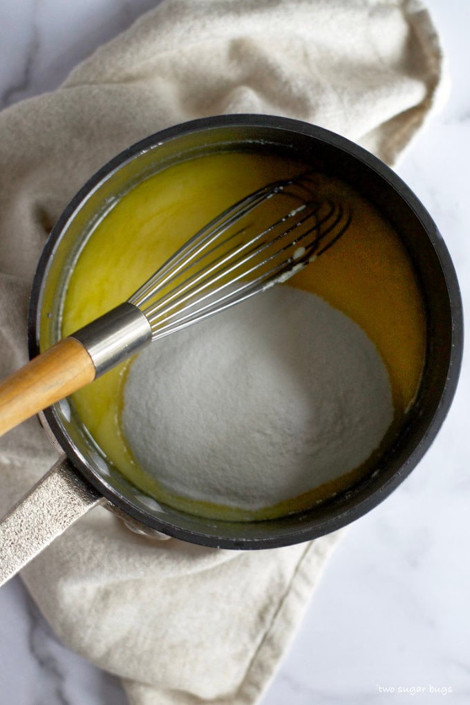 melted butter and white chocolate in a sauce pan with granulated sugar and a whisk