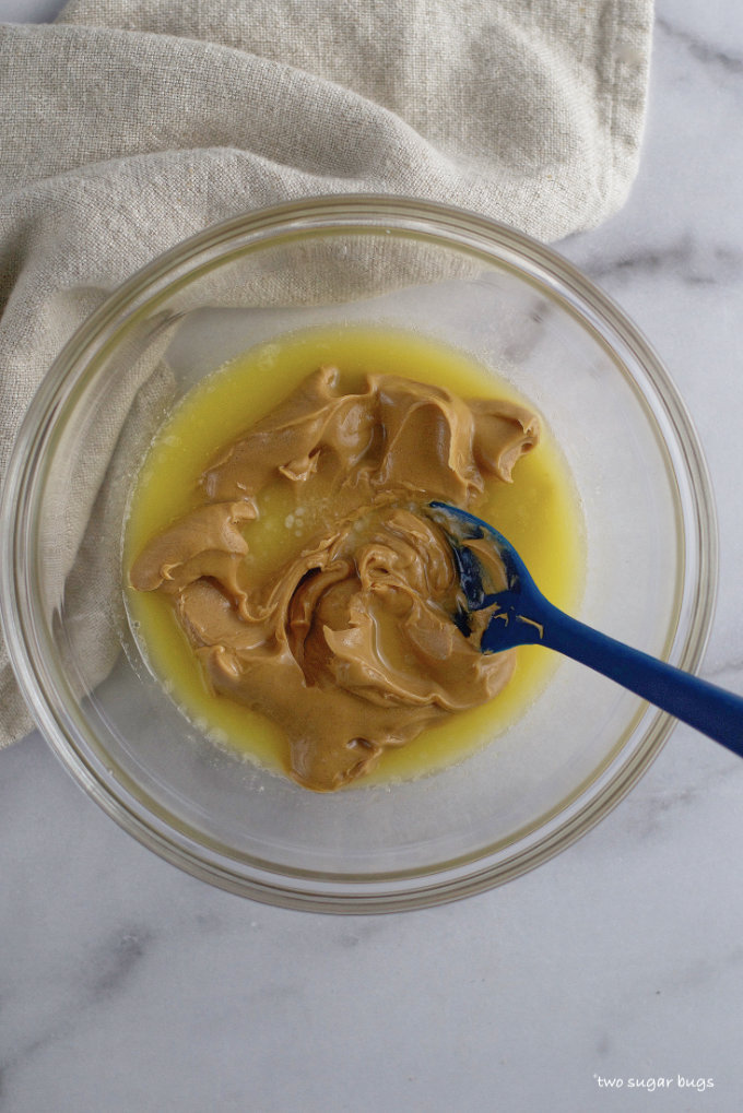 melted butter and peanut butter in a bowl with a spatula
