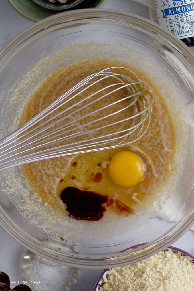 egg, almond and vanilla added to wet ingredients in a bowl