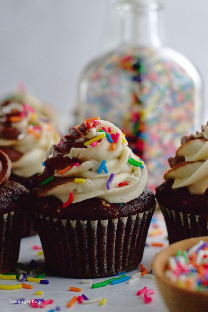 small batch chocolate cupcakes with a bottle of sprinkles