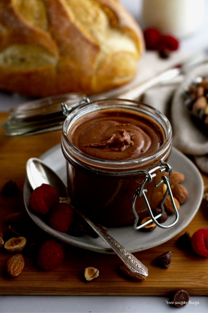 jar of homemade chocolate almond spread with a loaf of bread