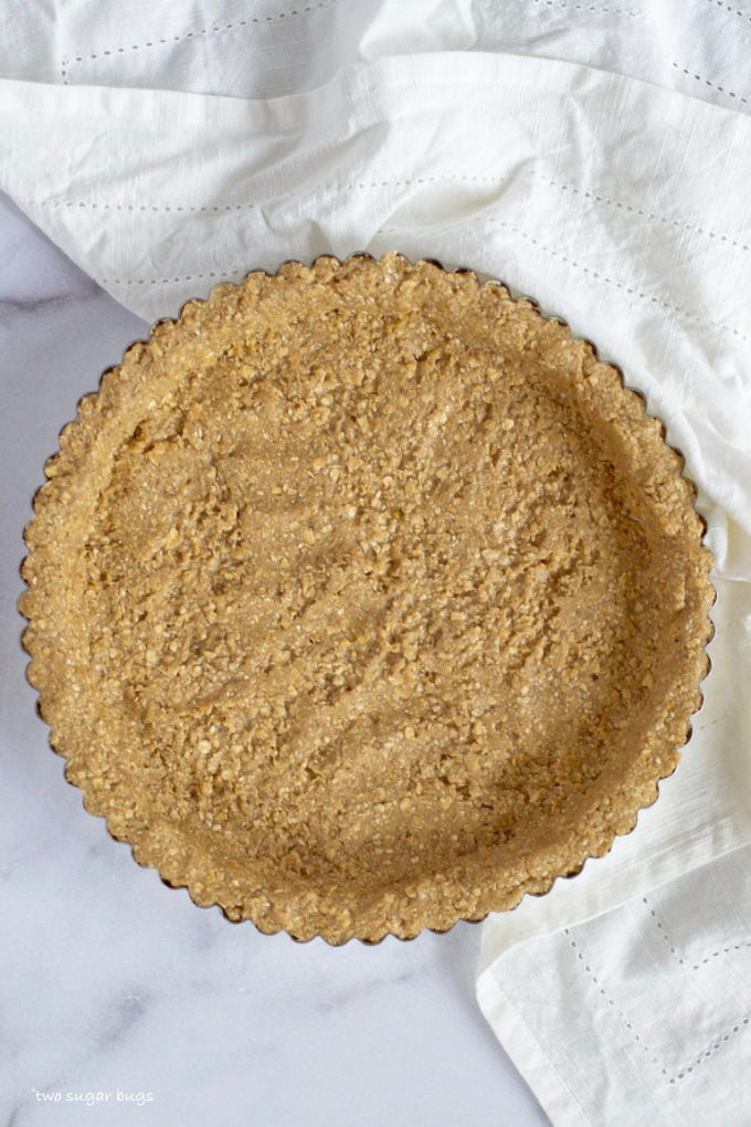chilled edible malted oatmeal cookie dough crust pressed into tart pan
