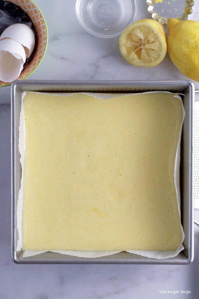 unbaked lemon layer on shortbread crust in the baking pan