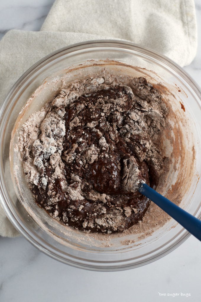 one bowl brownie mixture mixed with some large streaks of flour still showing