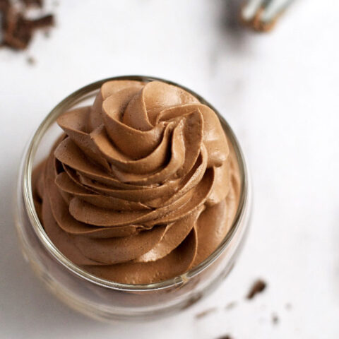 top down look at piped chocolate swiss meringue buttercream in a glass