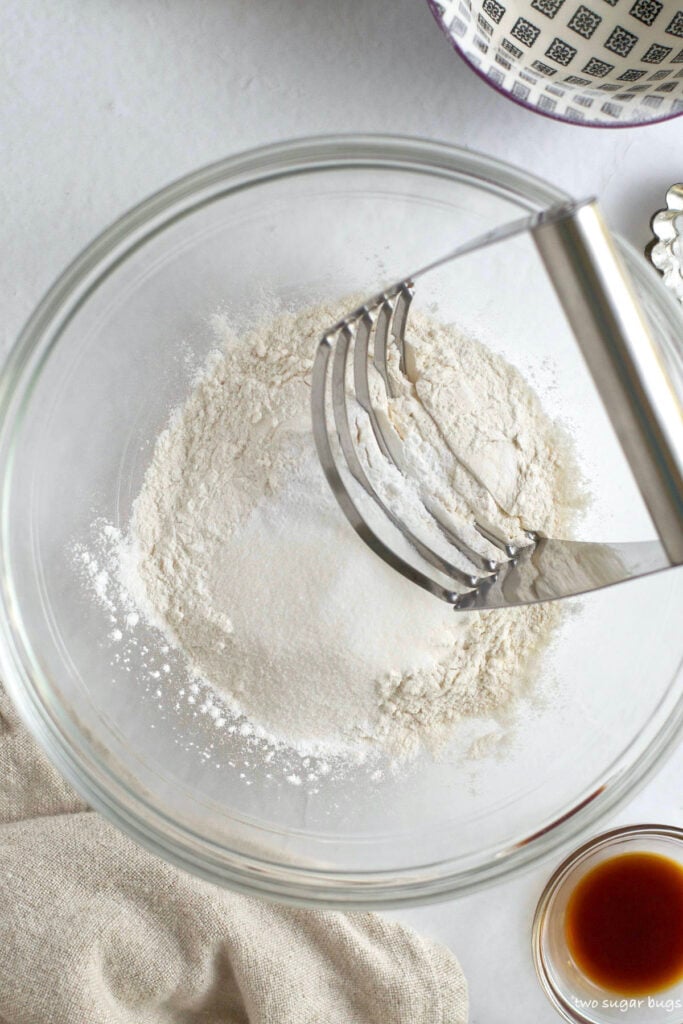 flour, sugar, baking powder and kosher salt in a mixing bowl with a pastry blender