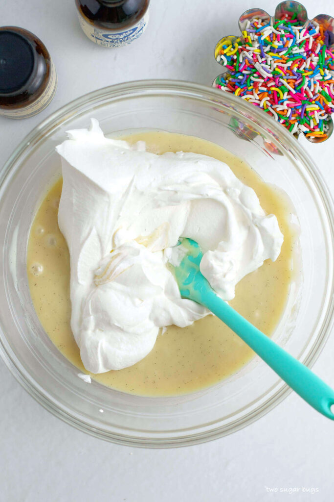 whipped cream being folded into sweetened condensed milk