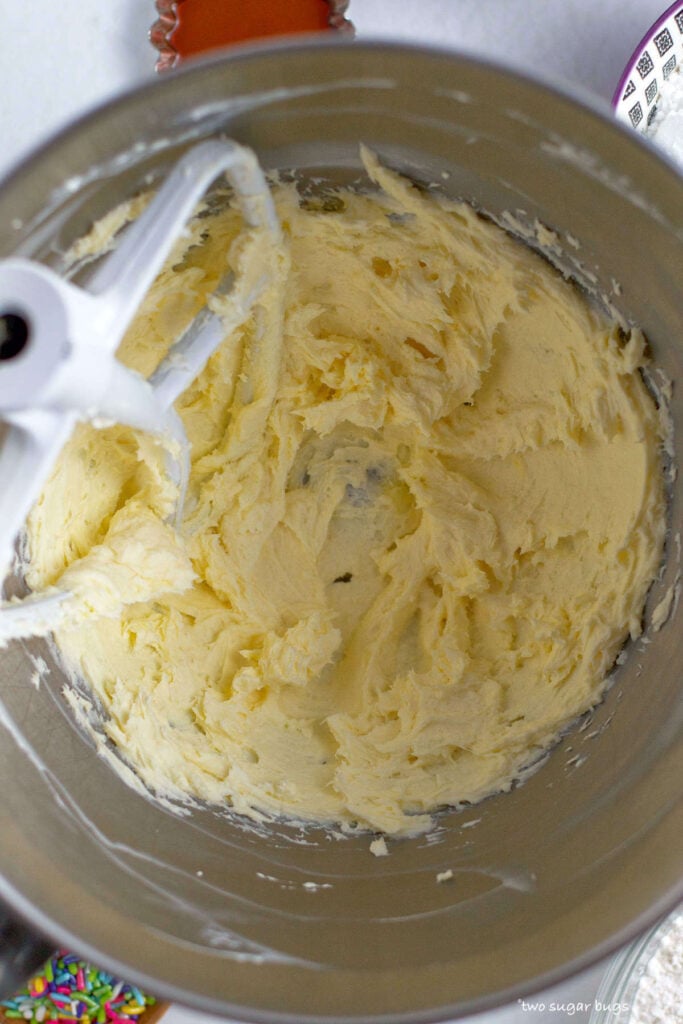 butter and cream cheese mixed together in a mixing bowl