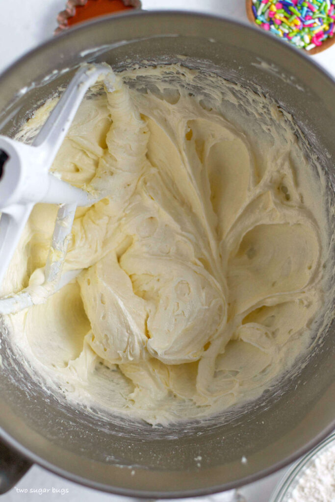 fluffy texture of butter, cream cheese and sugars mixed together in the mixing bowl