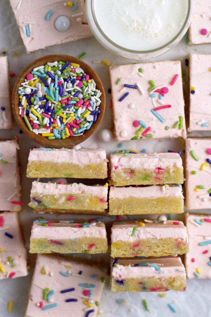over head look at sugar cookie bars with sprinkles and milk