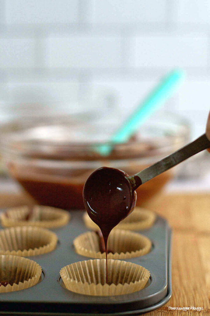 milk chocolate being poured into muffin tin
