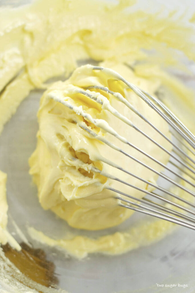 egg yolks and superfine sugar on a whisk