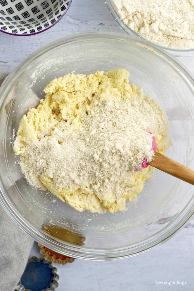 almond flour being added to the amaretti cookie dough