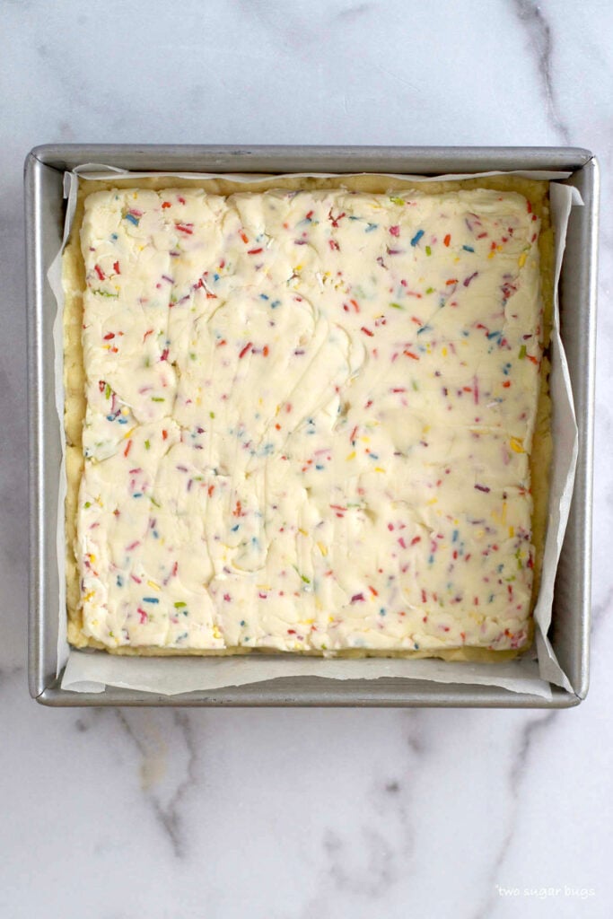 funfetti frosting layer on top of bottom layer of cookie dough