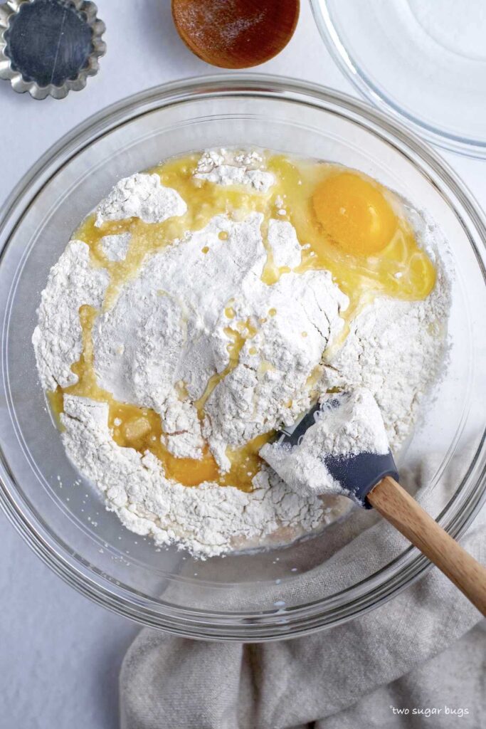 flour, eggs and melted butter in a bowl