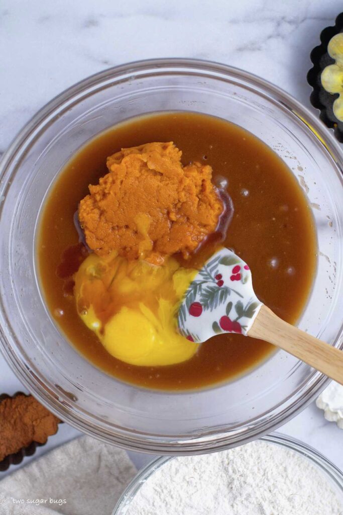 pumpkin puree, egg yolks and vanilla added to melted butter/sugars