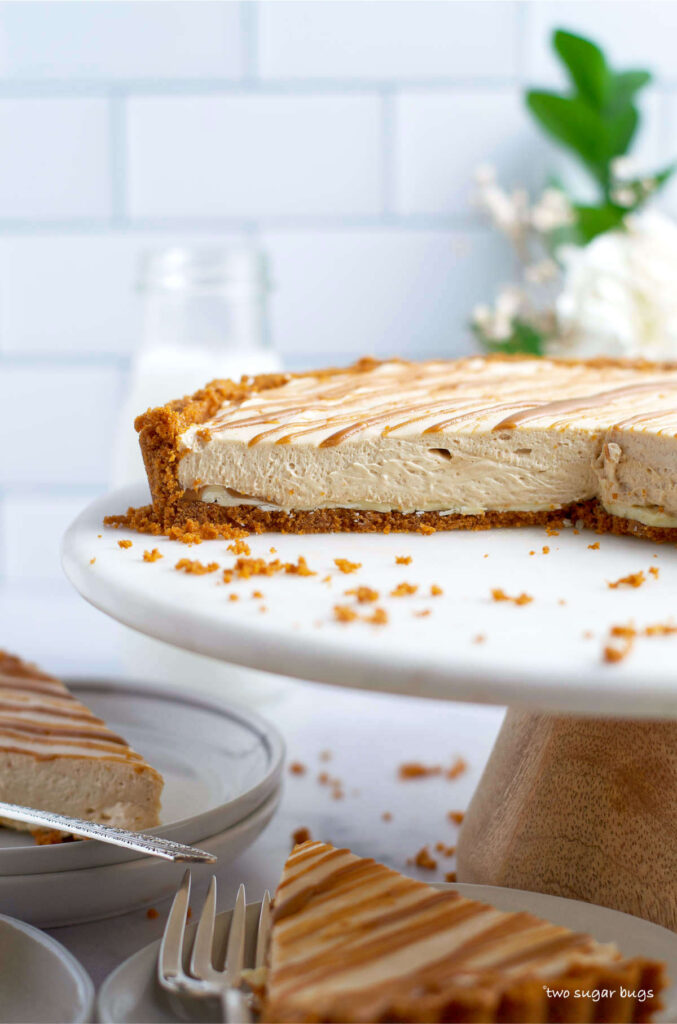 slices of biscoff cheesecake on plates and serving stand