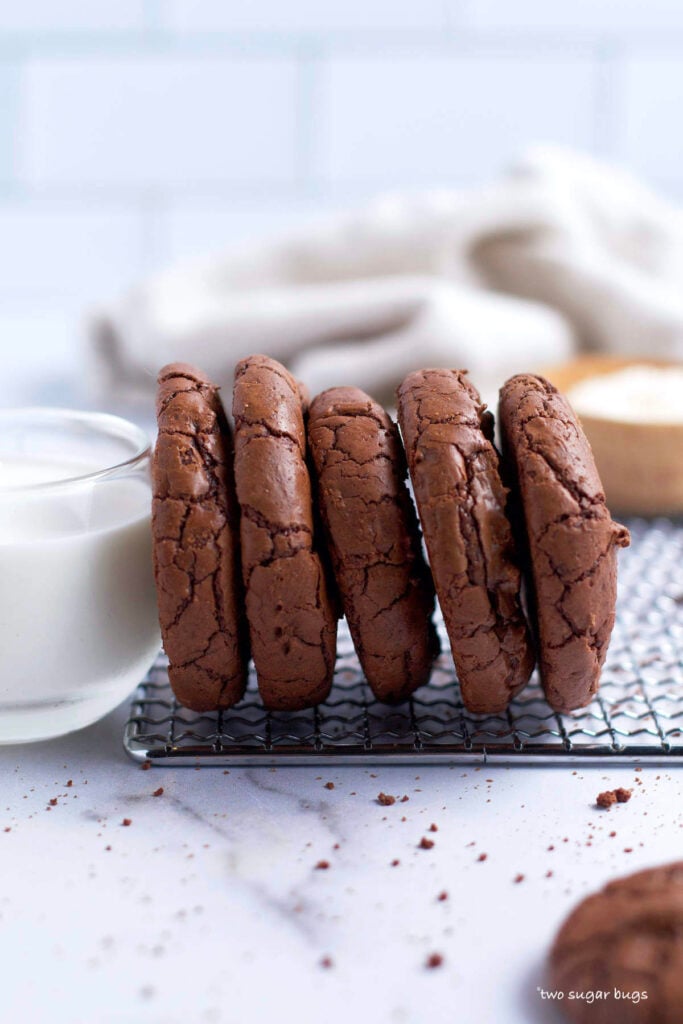 thick brownie crinkle cookies with a glass of milk
