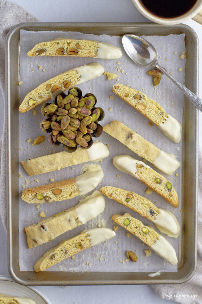 white chocolate dipped biscotti on a baking pan