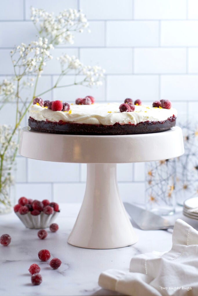 white chocolate cranberry tart on a cake stand