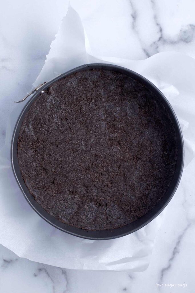 chocolate cookie crust pressed in a springform pan