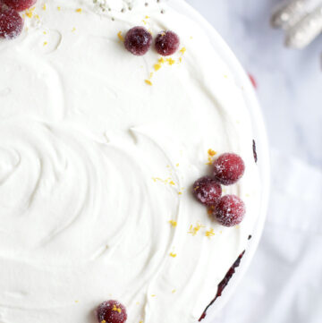 white chocolate-cranberry tart with sugared cranberries and orange zest