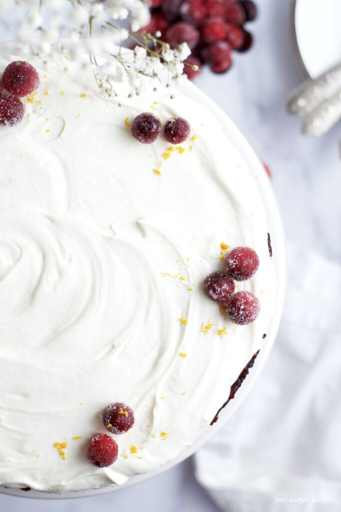 white chocolate-cranberry tart with sugared cranberries and orange zest