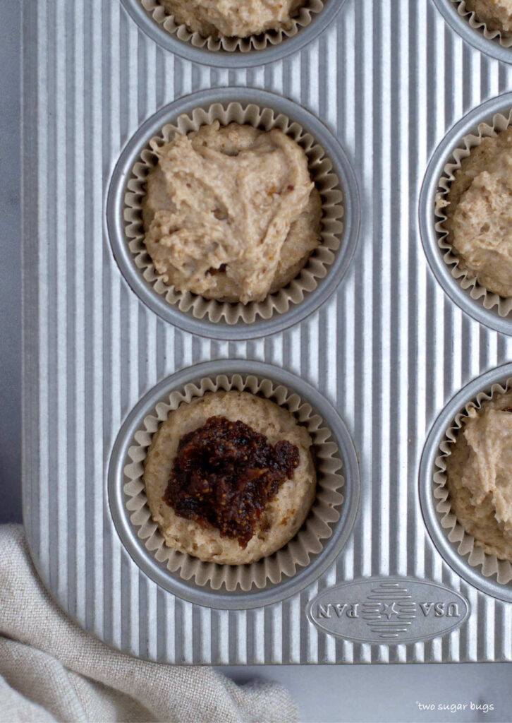 muffins in muffin pan showing fig jam center