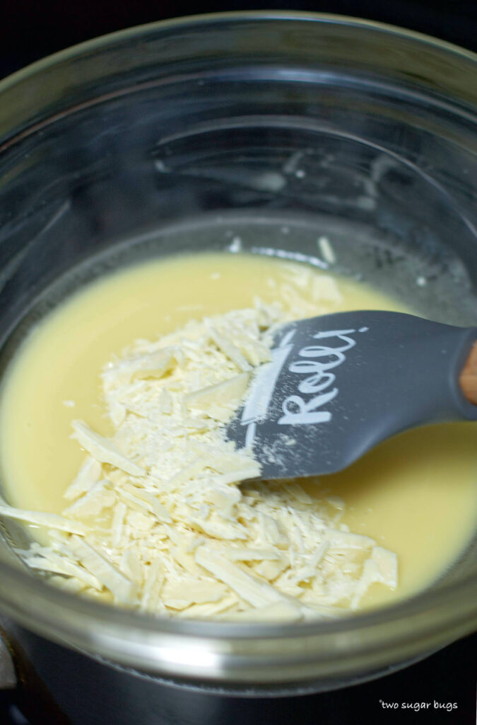 melted butter and white chocolate in a bowl over a pot of simmering water