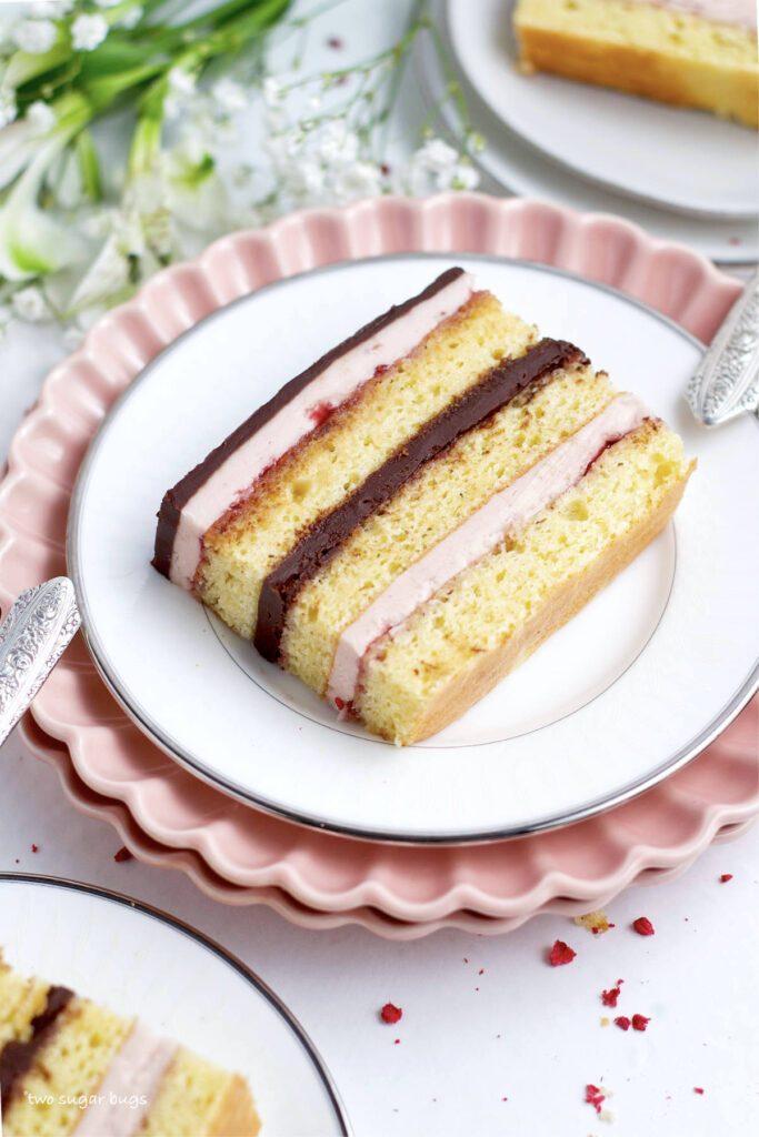 slice of raspberry opera cake on a plate