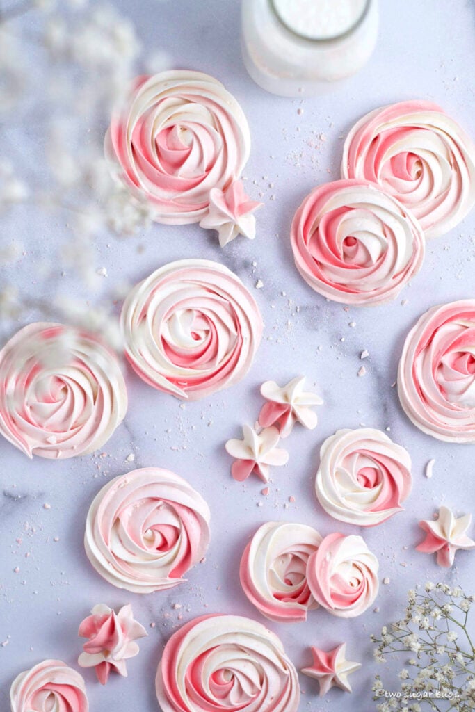 pink swirled meringue cookie rosettes and stars
