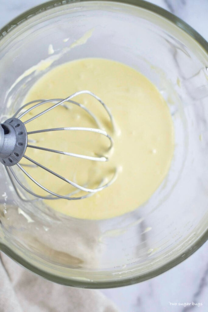 whipped eggs, sugar and white chocolate in a mixing bowl