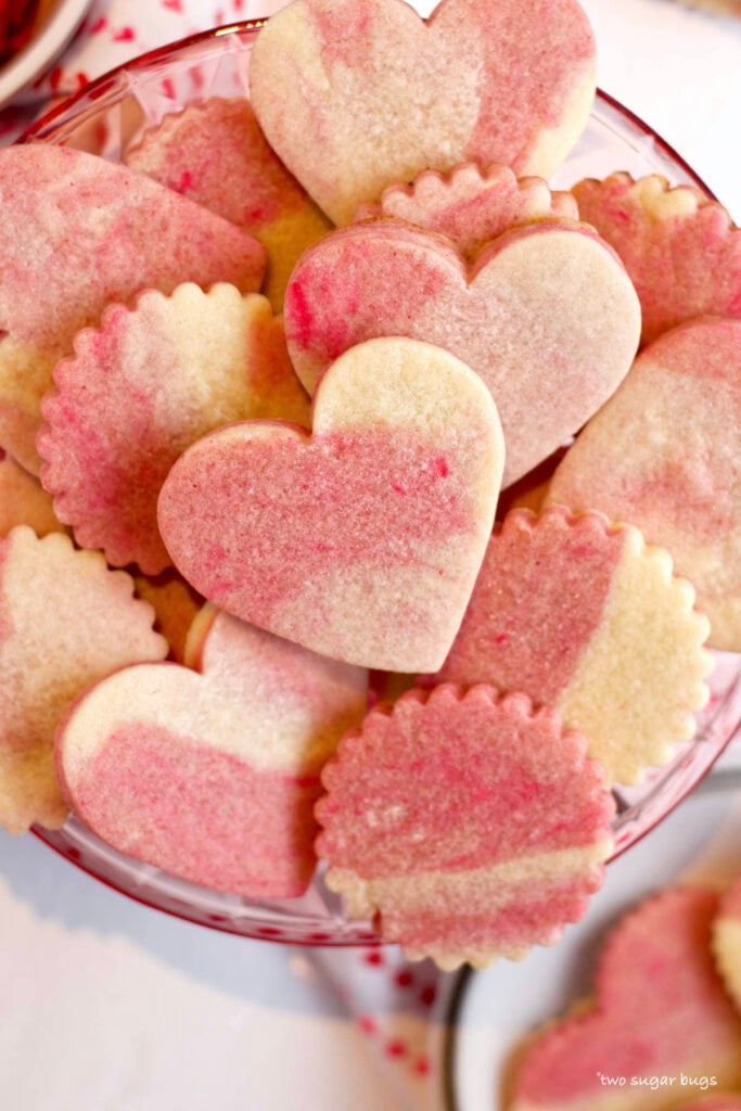 pile of cut out cookies on a pink plate