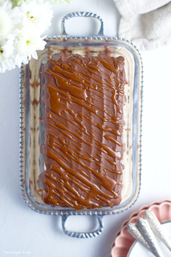 caramel drizzle over chocolate ganache on top of a cake