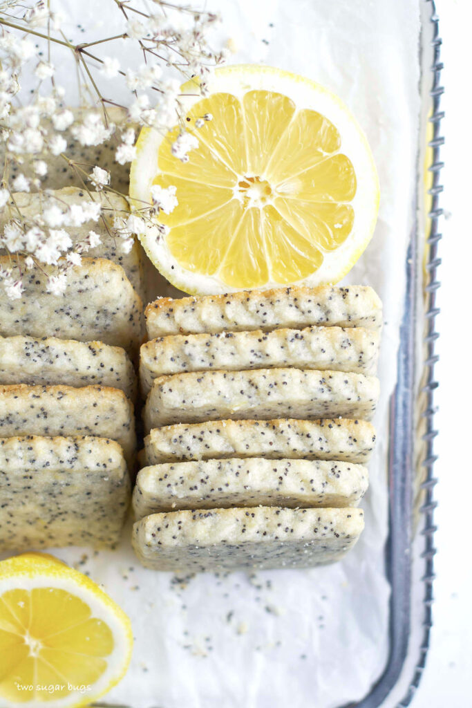 overhead look at lemon poppy seed cookies on a serving platter with lemon slices