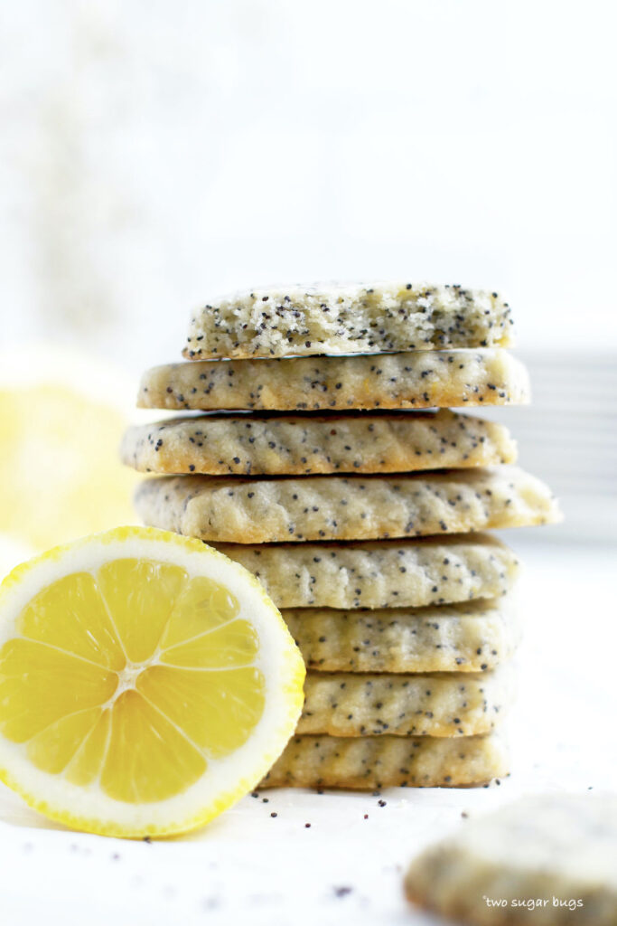 stack of lemon cookies with the top one showing the inside of the cookie